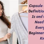 Pinterest pin titled "Capsule Wardrobe Tips What No One Tells You Before Starting – 7 Unfiltered Truths Every Beginner Needs to Hear (3).webp". The image features a smiling woman with curly hair holding a garment on a hanger, positioned next to text that defines the concept of a Capsule Wardrobe. This pin acts as a beginner's guide, explaining what a Capsule Wardrobe is and why it is a valuable asset for women's fashion.