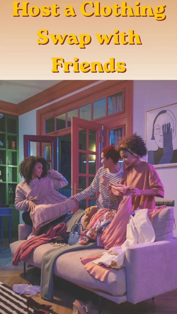 Women's fashion Pinterest pin from the file "Host a Clothing Swap with Friends.webp". The image shows three friends happily sorting through a pile of colorful garments, dresses, and accessories spread across a living room sofa. Bold yellow text at the top reads "Host a Clothing Swap with Friends". The pin highlights a fun, free, and sustainable way for women to refresh their style and trade pieces to build a budget-friendly Capsule Wardrobe.
