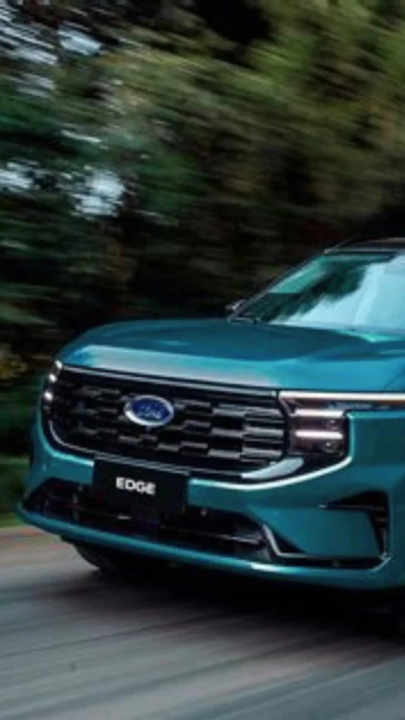 Pinterest pin titled "The 2026 Sustainable Edge.webp". The image shows a teal Ford Edge vehicle driving on a road, suggesting motion and modern design. This pin draws an unconventional parallel to the concept of a Capsule Wardrobe in women's fashion, emphasizing how streamlined, efficient, and intentional choices—much like the sleek performance of a vehicle—can provide you with a sustainable "edge" in simplifying your closet and daily life this year.