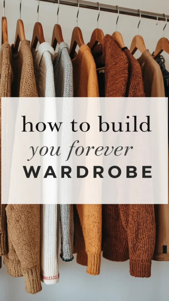 A Pinterest pin graphic featuring a light text overlay reading "how to build you forever WARDROBE" set against a close-up of cozy autumn knitwear on a clothing rack. Highlights thick sweaters neatly hanging on wooden hangers in warm seasonal colors, including beige, off-white, grey, mustard yellow, and rust brown. An ideal visual guide for curating timeless fall sweater essentials, organizing a minimalist closet, and building a versatile women's fashion Capsule Wardrobe.